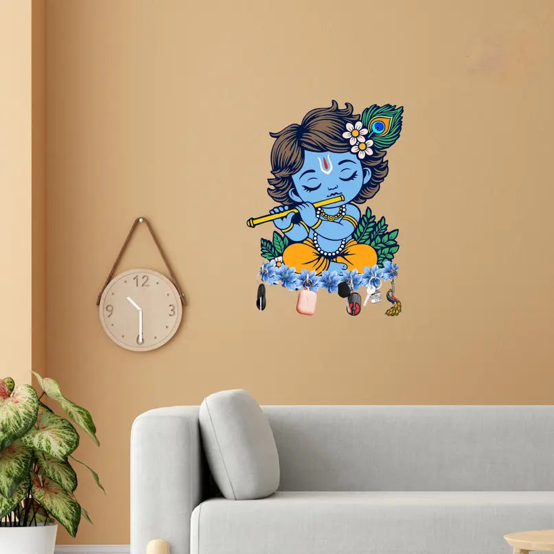 Wall decal of a blue-skinned figure with a flute on a beige wall above a gray sofa.